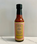 Rhinestone Cowboy Coffee Hot Sauce bottle showcasing its unique flavors for breakfast burritos.
